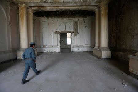 An Afghan policeman walks inside the Darul Aman palace in Kabul, Afghanistan, June, 2, 2016. REUTERS/Omar Sobhani