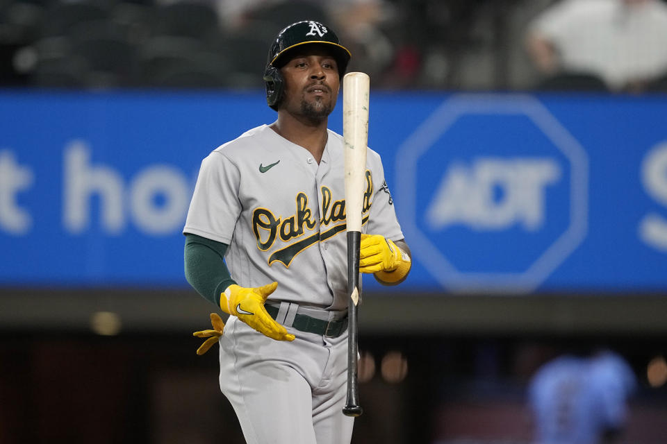 Oakland Athletics' Tony Kemp flips his bat in the air after being called out on strikes in the fourth inning of a baseball game against the Texas Rangers, Saturday, Sept. 9, 2023, in Arlington, Texas. (AP Photo/Tony Gutierrez)