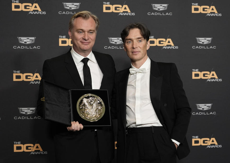 Christopher Nolan, left, director of "Oppenheimer," holds his DGA Awards Feature Film Medallion alongside cast member Cillian Murphy backstage at the 76th DGA Awards, Saturday, Feb. 10, 2024, in Beverly Hills, Calif. (AP Photo/Chris Pizzello)