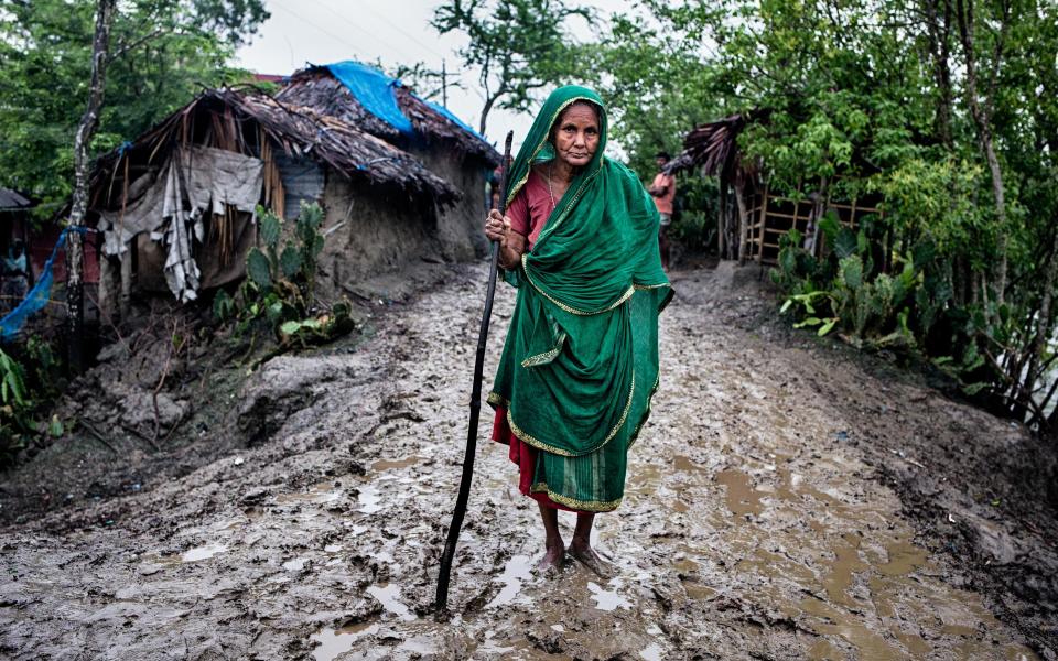 Zohora (92) walks along a muddy road in Kholpetuya village, searching for food for her grandchildren - Fabeha Monir/Oxfam