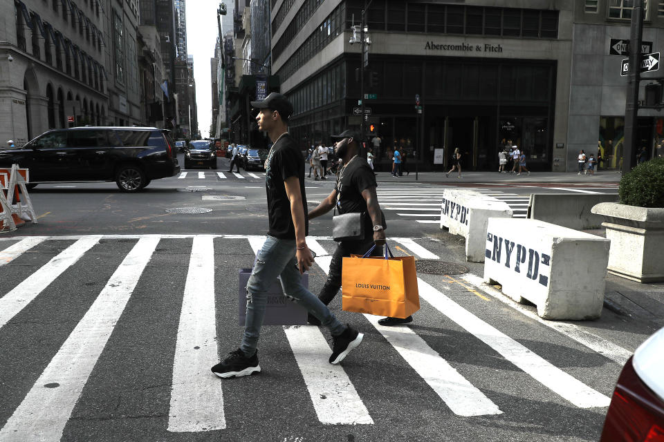 NEW YORK, NEW YORK - SEPTEMBER 06: Shoppers with bags cross the street in Midtown on September 06, 2021 in New York City. (Photo by John Lamparski/Getty Images)