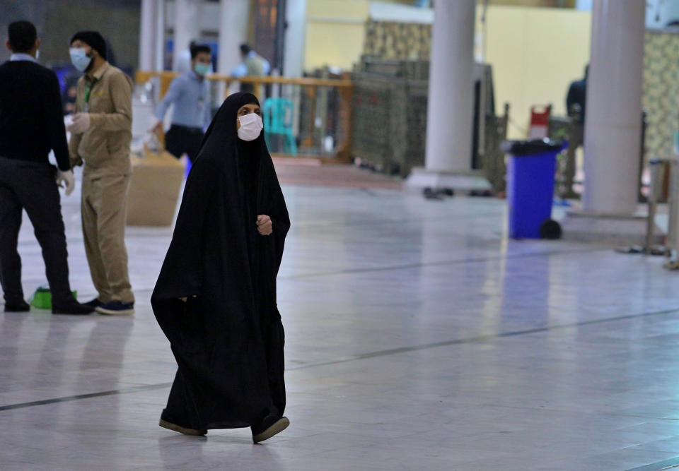 In this Monday, Feb. 24, 2020 photo, some Shiite pilgrims visit the shrine of Imam Ali in Najaf, Iraq, The Health Ministry said four new cases of coronavirus were diagnosed in the northern province of Kirkuk. It said the afflicted were members of an Iraqi family who had returned from a recent trip to Iran. Iraq announced the discovery of the first coronavirus case in the country on Monday in Najaf. Iraq had earlier closed its border with Iran to Iranian nationals but apparently Iraqis can still cross the boundary. (AP Photo/Anmar Khalil)