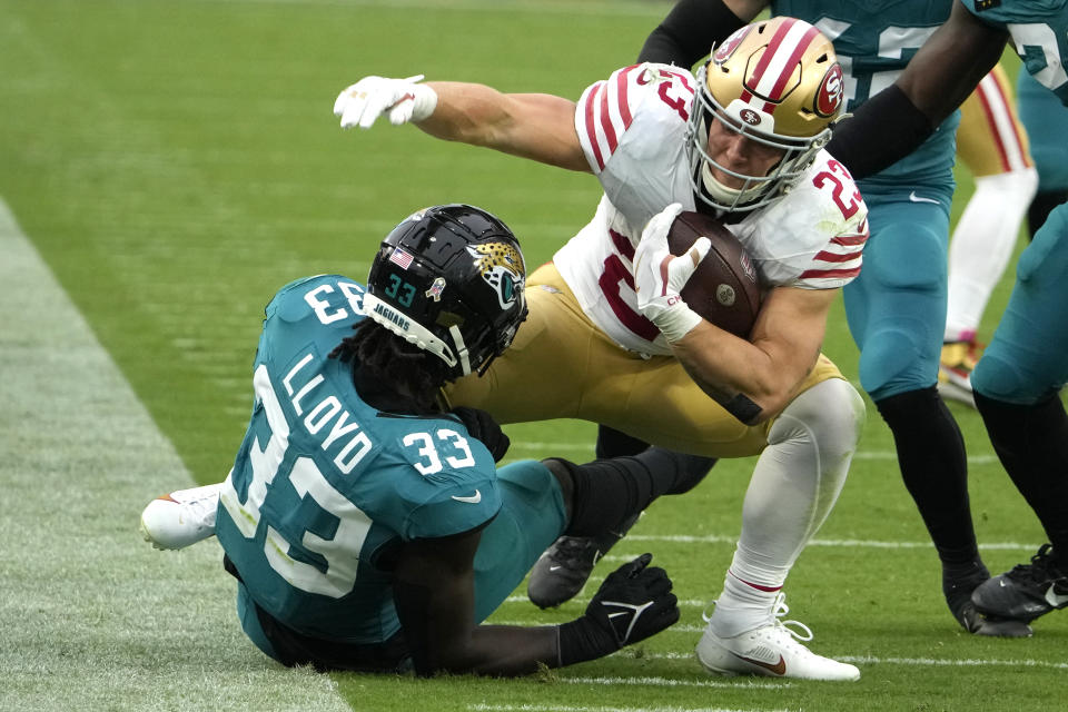 San Francisco 49ers running back Christian McCaffrey (23) is tackled by Jacksonville Jaguars linebacker Devin Lloyd (33) during the second half of an NFL football game, Sunday, Nov. 12, 2023, in Jacksonville, Fla. (AP Photo/John Raoux)