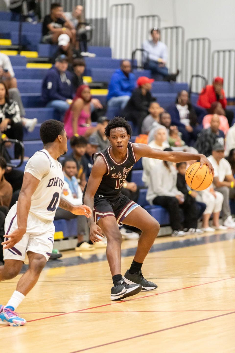 Lake Worth basketball's Tariq Mcleod dribbles against Dwyer on Jan. 30, 2024.