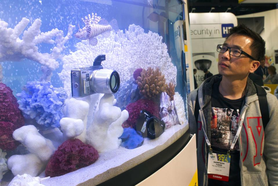 Sampson Yang looks at a waterproof Nikon 1 Aw1 at the Nikon booth during the 2014 International Consumer Electronics Show (CES) in Las Vegas