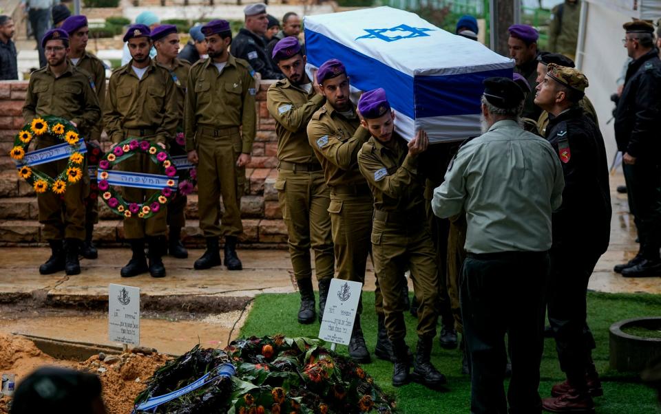 Israeli soldiers carry the flag-draped casket of Staff Sgt. Birhanu Kassie during his funeral