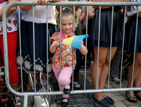 A girl attends a ceremony marking the Day of the State Flag, on the eve of the Independence Day, in Kiev, Ukraine. REUTERS/Gleb Garanich