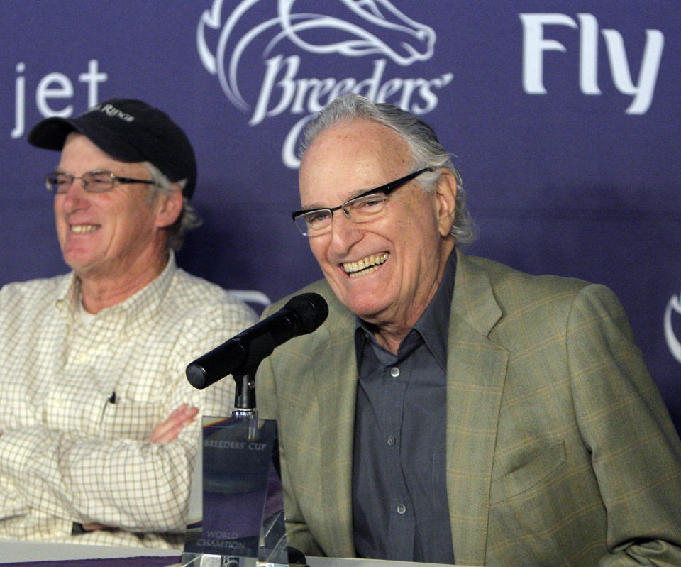 FILE - Horse breeder Jerry Moss, owner of Zenyatta appears during a news conference with trainer John Shirreffs, left, after the Breeders' Cup draw at Santa Anita Park in Arcadia, Calif., on Nov. 3, 2009. Moss, a music industry giant who co-founded A&M Records, died Wednesday at his home in Bel Air, Calif. He was 88. (AP Photo/Jae C. Hong, File)
