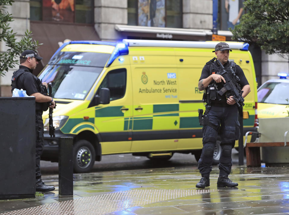 Police outside the Arndale Centre in Manchester, England, Friday October 11, 2019, after a stabbing incident at the shopping center that left four people injured. Greater Manchester Police say a man in his 40s has been arrested on suspicion of serious assault. He had been taken into custody. (Peter Byrne/PA via AP)
