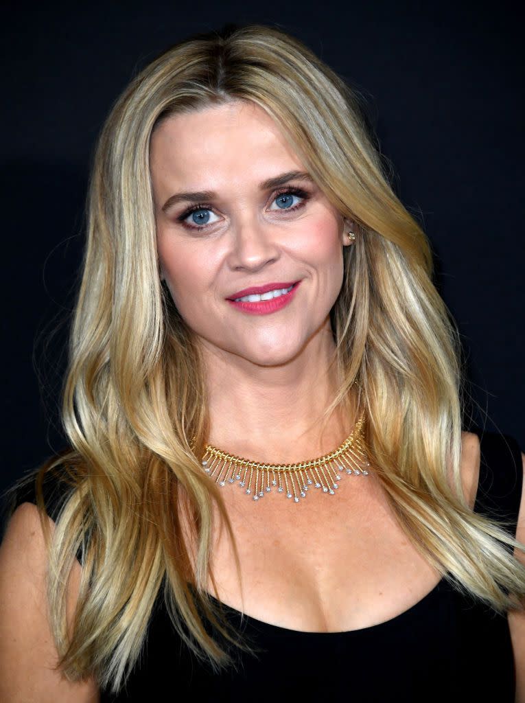 reese witherspoon smiling for a photo at a premiere event