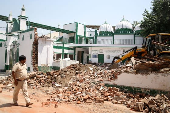 A bulldozer is demolishing an alleged illegal structure of a Bengali market mosque during an anti-encroachment drive by the New Delhi Municipal Corporation (NDMC) on April 11. <span class="copyright">Salman Ali—Hindustan Times/Getty Images</span>