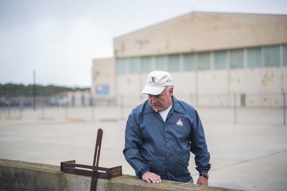 Curtis Gandy, CEO and founder of the former Fort Ord Toxics Project, stands near where he used to work in Marina, Calif. on Aug. 24, 2021. According to a roster of Gandy’s co-workers from one day at the airfield in 1986, there were 46 pilots and welders, mechanics and radio engineers. Today one-third of them have died, many of cancers and rare diseases, some in their 50s. (AP Photo/Nic Coury)