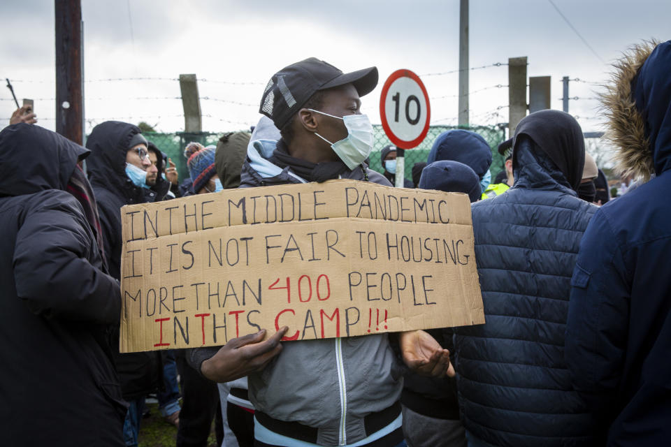 Asylum seekers currently held inside Napier Barracks staged a peaceful protest outside the entrance to the barracks with banners and signs to demonstrate about the poor conditions they are subjected to inside the holding centre on the 12th of January 2021 in Folkestone, United Kingdom. Over 400 asylum seekers are being kept at Napier Barracks in unsuitable, cold accommodation, they are experiencing mental health issues as well as being vulnerable to health conditions including COVID-19.  (photo by Andrew Aitchison / In pictures via Getty Images)