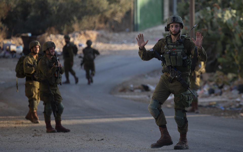 Israeli troops patrol the streets and search houses during an army operation following a stone throwing attack on an Israeli driver near the Allon Moreh Israeli settlement, at the West Bank village of Salem, near Nablus, Monday, Aug. 23, 2021. (AP Photo/Majdi Mohammed)