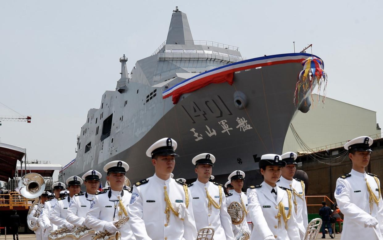Members of Taiwanese honor guard walk during the official launching of Taiwan's new amphibious transport dock
