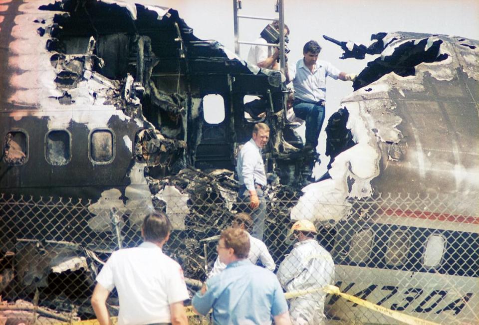 Aug. 31, 1988: Investigators climb through the wreckage of Delta 1141, which crashed during takeoff from Dallas-Fort Worth International Airport.