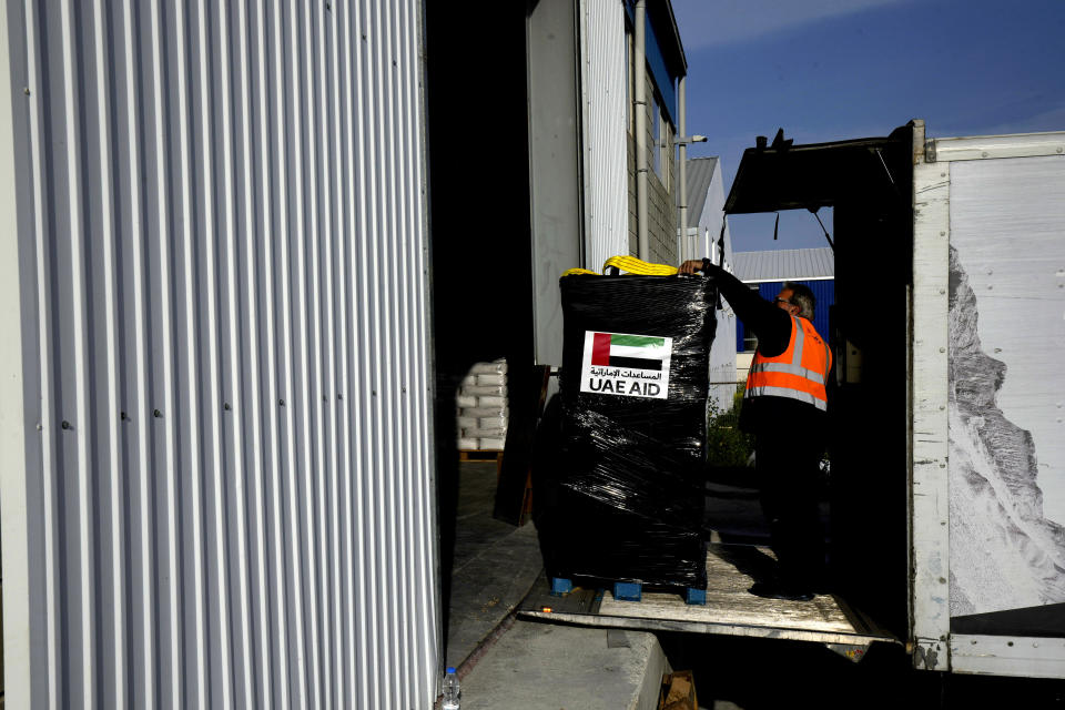 A worker use a lift loading humanitarian aid pallets inside a truck for transport to the port of Larnaca from where it will be shipped to Gaza, at a warehouse near Larnaca, Cyprus, on Wednesday, March 13, 2024. Cyprus' foreign minister Constantinos Kombos said that a second vessel being loaded with aid for Gaza is currently docked at Larnaca port and is preparing to depart. (AP Photo/Petros Karadjias)