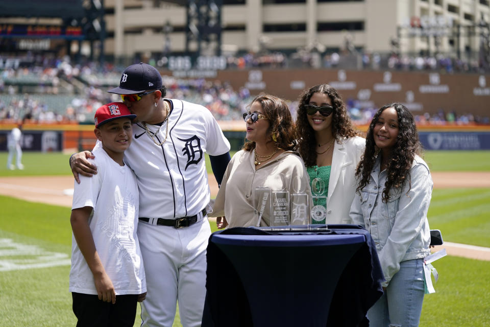 Detroit Tigers designated hitter Miguel Cabrera kisses his son Christopher during a pregame ceremony of a baseball game against the Toronto Blue Jays, Sunday, June 12, 2022, in Detroit. Cabrera was honored for his 3,000th career hit. From left are Christopher Cabrera, Miguel, wife Rosangel, daughters Brisel and Isabella. (AP Photo/Carlos Osorio)