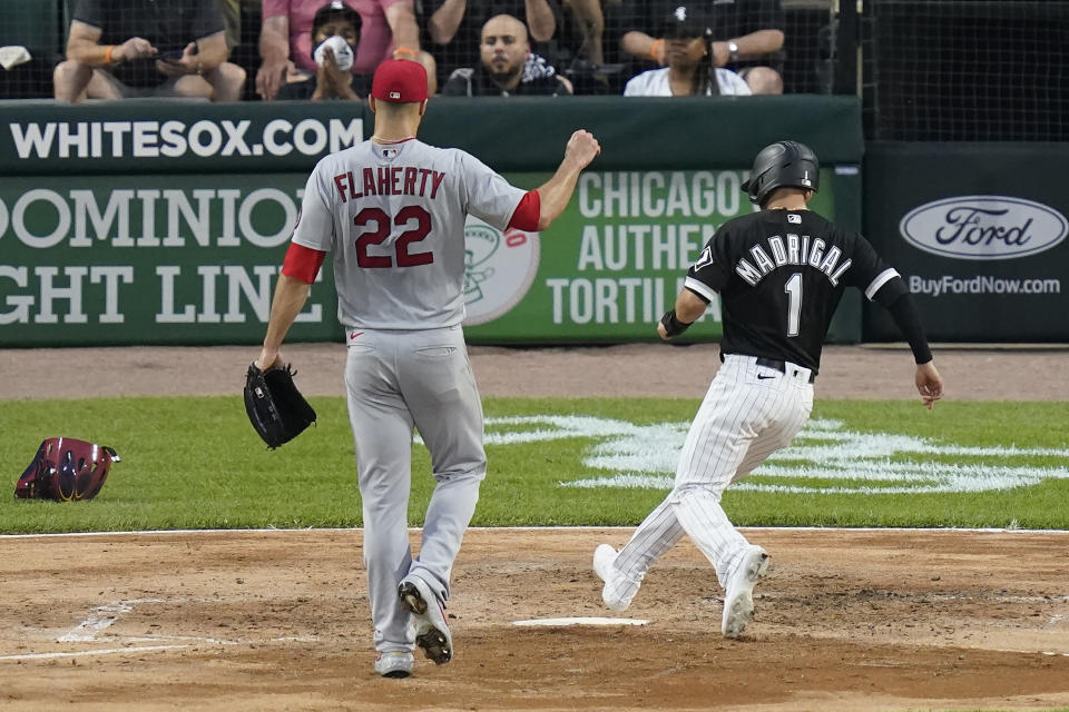 Chicago White Sox's Nick Madrigal (1) scores on a wild pitch from St. Louis Cardinals starting pitcher Jack Flaherty during the second inning of a baseball game Tuesday, May 25, 2021, in Chicago. (AP Photo/Charles Rex Arbogast)