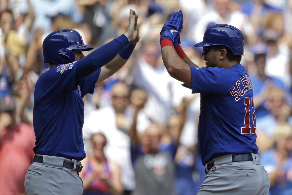 Chicago Cubs' Kyle Schwarber, right, is congratulated by Ian Happ after hitting a three-run home run during the fourth inning of a baseball game against the Milwaukee Brewers, Sunday, July 28, 2019, in Milwaukee. (AP Photo/Aaron Gash)