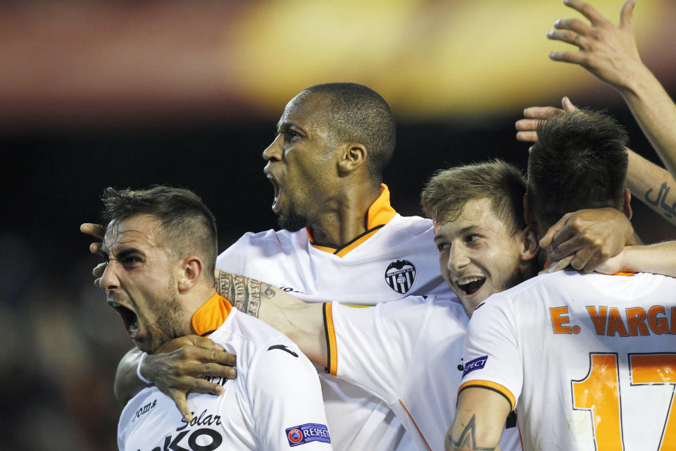 Valencia’s Paco Alcacer, left, celebrates scoring against Basel with teammates Seydou Keita, center, and Fede Cantabria, right, during the Europa League quarterfinal, second leg soccer match at the Mestalla stadium in Valencia, Spain, on Thursday, April 10, 2014. Valencia lost 3-0 in the first leg at Basel. (AP Photo/Alberto Saiz)