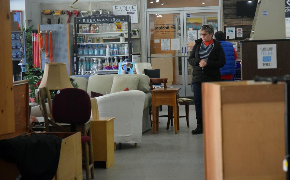 Lisa Cline (black coat) browses through furniture for sale at Northwest Habitat for Humanity ReStore in Petoskey on Tuesday, March 14.