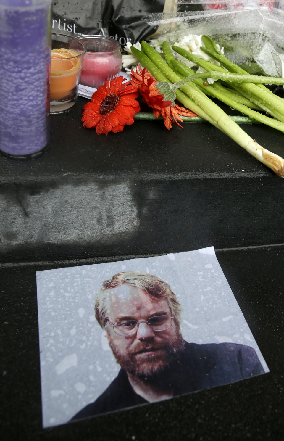 A makeshift memorial is seen, Monday, Feb. 3, 2014, outside the building where the body of actor Philip Seymour Hoffman was found in New York. Hoffman, 46, was found dead Sunday in his apartment. (AP Photo/Seth Wenig)