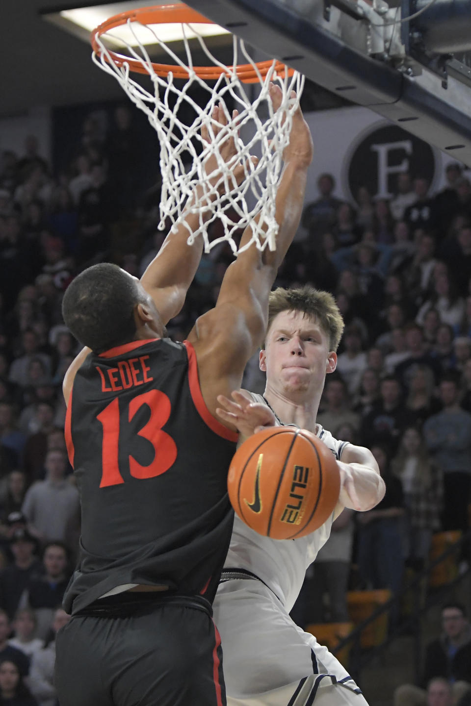 Utah State guard Max Shulga, right, passes the ball past San Diego State forward Jaedon LeDee (13) during the second half of an NCAA college basketball game Wednesday, Feb. 8, 2023, in Logan, Utah. (AP Photo/Eli Lucero)