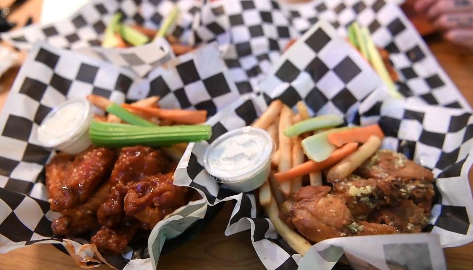 Thai chili wings, left, and parmesan wings, right, at Sharky's Wings and Raw Bar in Clifton.