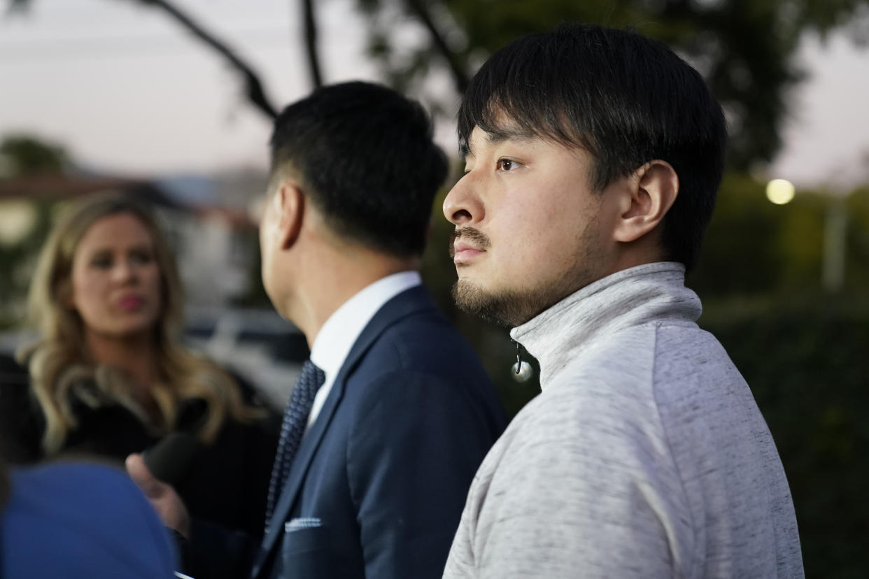 Brandon Tsay, 26, right, and his father, Tom Tsay, make a statement outside their home on Monday, Jan. 23, 2023, in San Marino, Calif. Brandon Tsay disarmed a gunman who killed multiple people late Saturday amid Lunar New Years celebrations in the predominantly Asian American community of Monterey Park. The gunman started at the Star Ballroom Dance Studio in Monterey Park and continued to Lai Lai Ballroom and Studio in Alhambra, where he was disarmed by Tsay. (AP Photo/Ashley Landis)