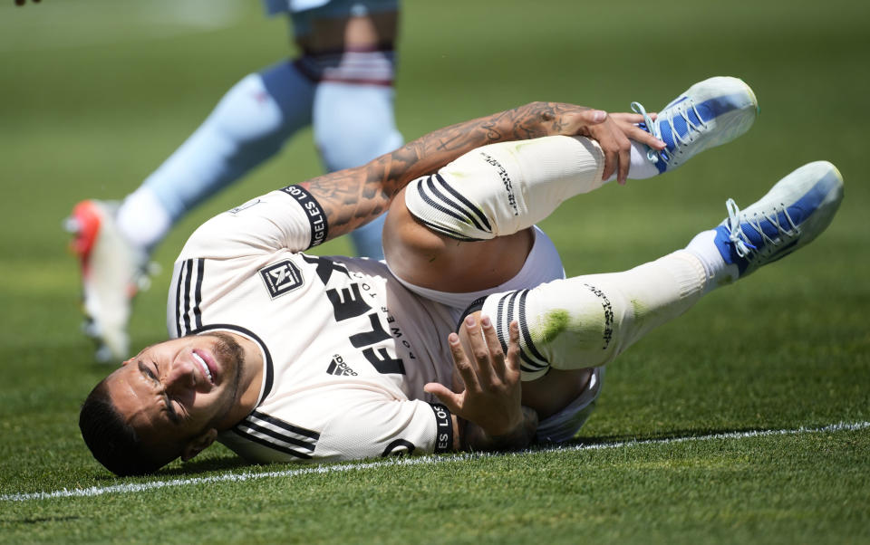 Los Angeles FC forward Cristian Arango reacts after colliding with Colorado Rapids defender Auston Trusty in the first half of an MLS soccer match Saturday, May 14, 2022, in Commerce City, Colo. (AP Photo/David Zalubowski)