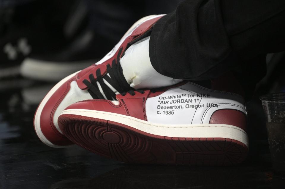 A fan sitting courtside at the Dec. 23 matchup between the Orlando Magic and the New Orleans Pelicans sports a pair of Off-White Air Jordan 1 Nike shoes.