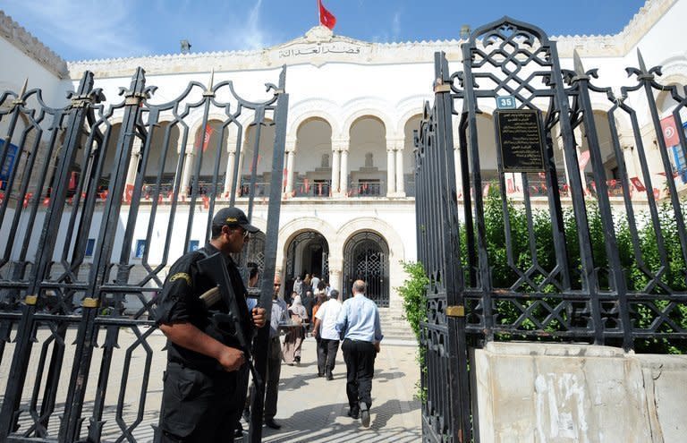 A policeman stands guard in front of the court in Tunis, on June 5, 2013. The court adjourned to next week the trial of three European women for holding a topless anti-Islamist protest and rejected their request for bail, their lawyers said