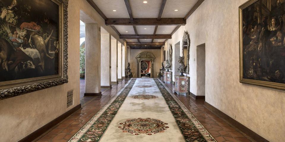 <p>The main hallway is 82 feet long, and features beamed ceiling and column details. </p>