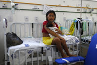 A Yanomami woman holds her baby, who is treated at the Santo Antonio Children's Hospital, in Boa Vista, Roraima state, Brazil, Thursday, Jan 26, 2023. Brazil's government declared a public health emergency for the Yanomami people in the Amazon, who are suffering from malnutrition and diseases such as malaria. (AP Photo/Edmar Barros)