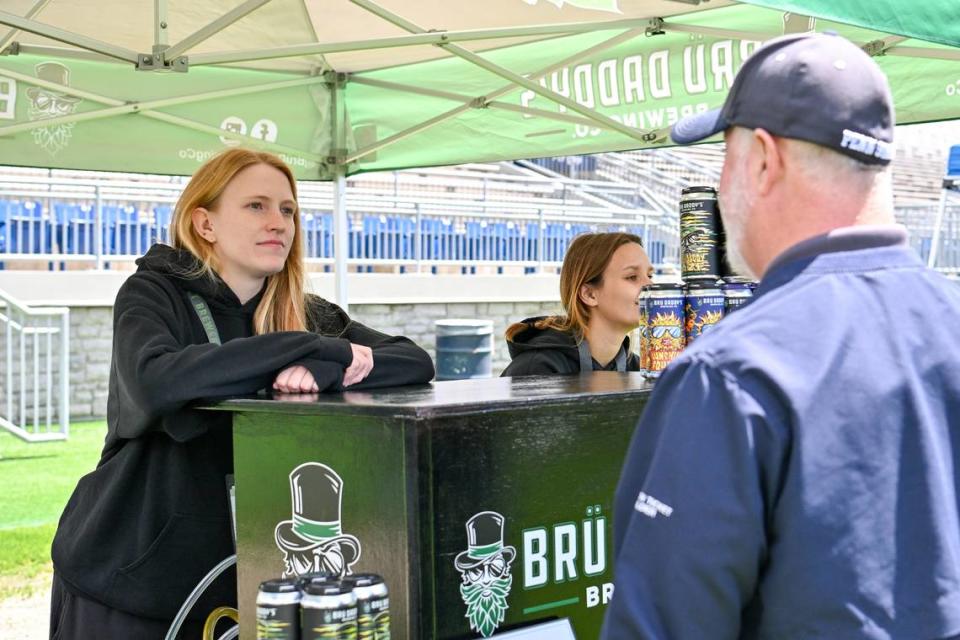 A representative from Brü Daddy’s Brewing Company in Allentown talks to an attendee during the Hoppy Valley Brewers Fest on Saturday at Penn State’s Beaver Stadium. Jeff Shomo/For the CDT