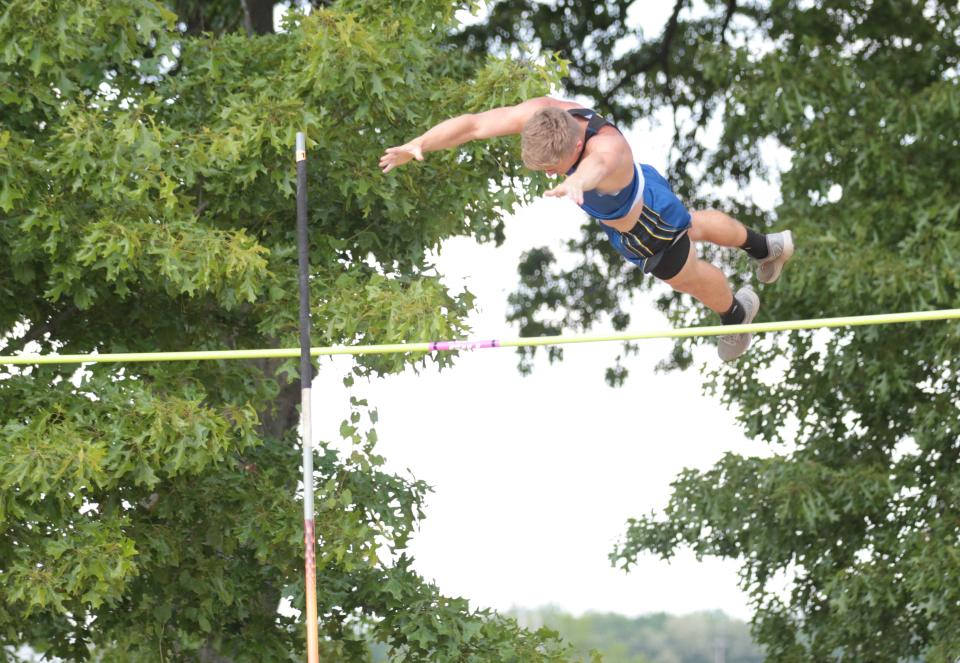 Gavin Bunning of Centreville soars over the bar in the pole vaulting event on Tuesday.