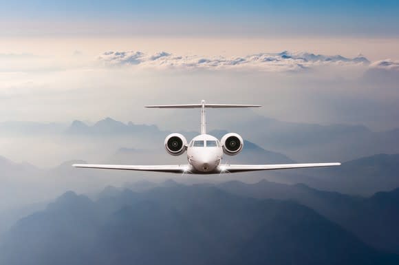 Private jet flying above the clouds.