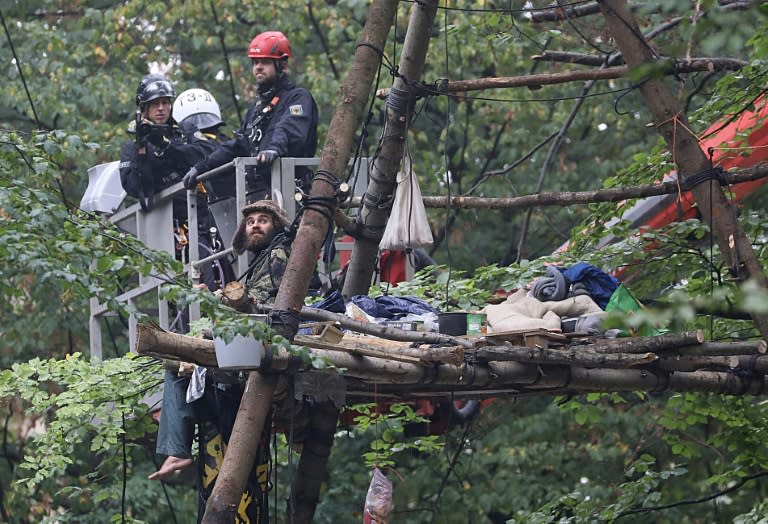 Policemen on a lifting platform close in as they prepare to evict activists after warning that the height at which the demonstrators were hunkering down was dangerous