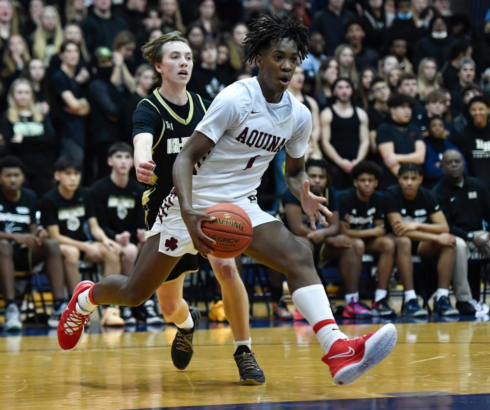 Aquinas' Mason Blackwood, right, drives to the basket past R-H’s Tobey Wright during the Section V Class AA Championship at Gates Chili High School, Saturday, March 5, 2022. No. 2 seed Aquinas No. 8 seed Rush-Henrietta.