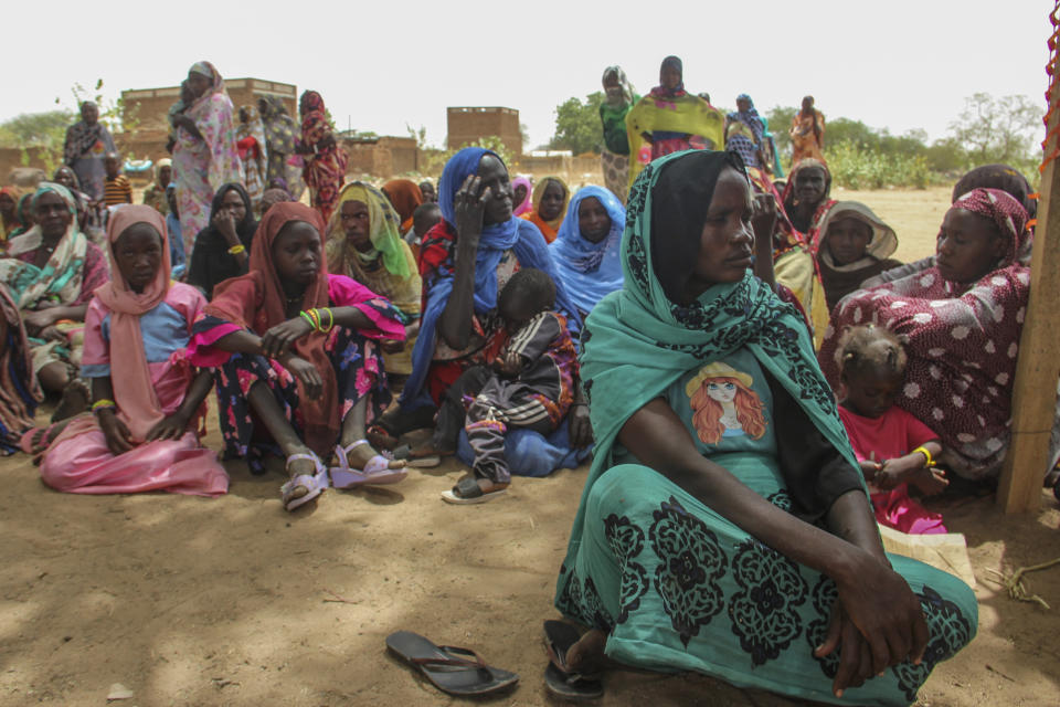 In this photo provided by UNICEF, a group of refugees rests under the shade of a tree to protect themselves from the sun and heat after crossing into the village of Koufroun, near the Chad-Sudan border, in Chad Thursday, April 27, 2023. Heavy explosions and gunfire rocked Sudan's capital early Friday, residents said, despite the extension of a fragile truce between the county's two top generals whose power struggle has killed hundreds. (Donaig Le Du/UNICEF via AP)