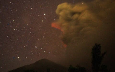 A bright red sky is seen from Besakih village of Karangasem regency, 7 kilometers from the erupted Mount Agung in Bali - Credit: Getty