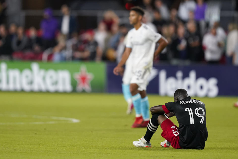 D.C. United forward Nigel Robertha (19) sits on the field after an MLS soccer match against the New England Revolution, Wednesday, Oct. 20, 2021, in Washington. The Revolution won 3-2. (AP Photo/Alex Brandon)