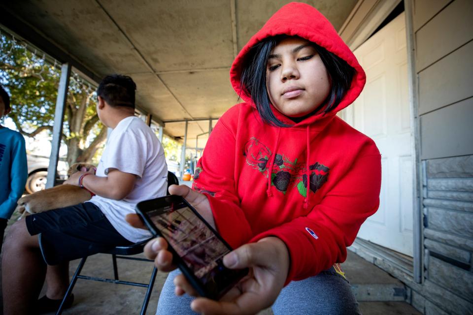 Jessica Hernandez , 14 holds her phone as she shows a video she made where Jessiram Hweih Rivera was shot by Polk County Sheriff Deputy Sean Speakman as she was coming toward him wielding a shovel near her home on a dirt road off Rifle Range Road in Wahneta Fl. Tuesday November 23 2021.  ERNST PETERS/ THE LEDGER