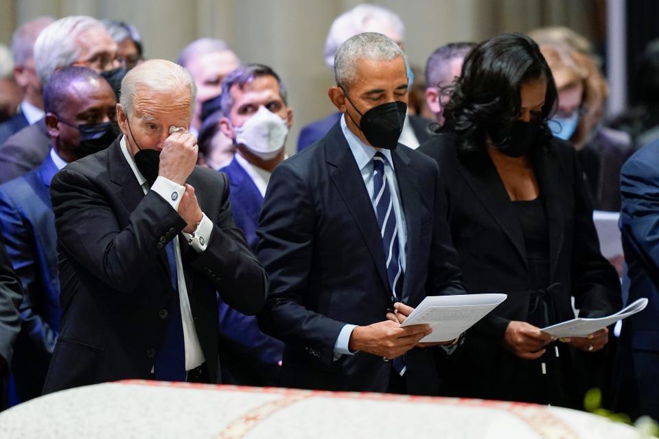 President Joe Biden wipes his eye during the funeral service for former Secretary of State Madeleine Albright at the Washington National Cathedral, Wednesday, April 27, 2022, in Washington. Former President Barack Obama and former first lady Michelle Obama stand with Biden. (AP Photo/Andrew Harnik) ORG XMIT: DCAH472