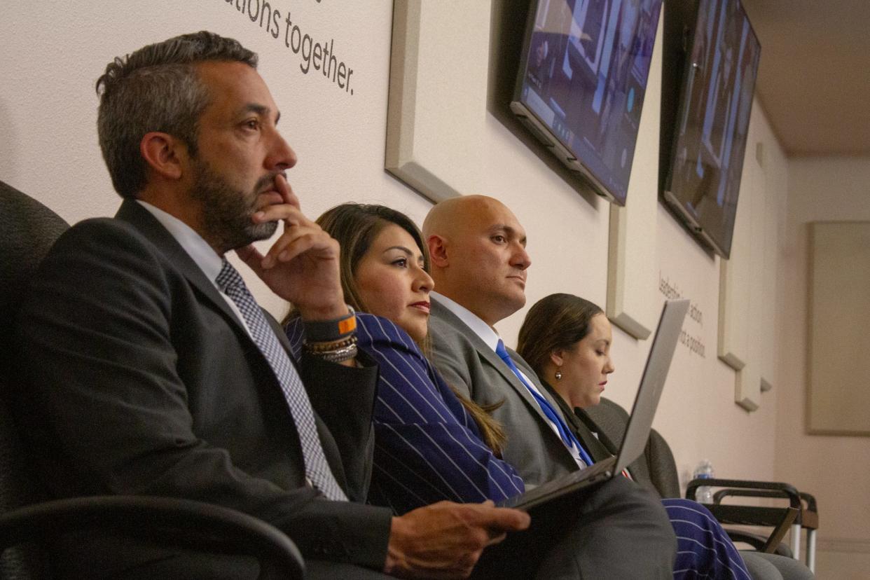 (left) Attorney Felix Valenzuela sits next to East-Central city Rep. Cassandra Hernandez (middle) and her husband, Jeremy Jordan, as she listens to public comments about her character during the Ethics Review Commission hearing on July 20, 2023.