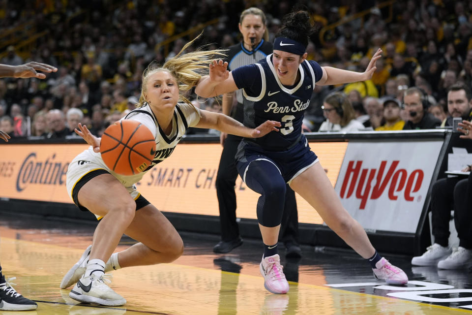 Iowa guard Sydney Affolter, left, fights for a loose ball with Penn State guard Moriah Murray, right, during the second half of an NCAA college basketball game, Thursday, Feb. 8, 2024, in Iowa City, Iowa. Iowa won 111-93. (AP Photo/Charlie Neibergall)