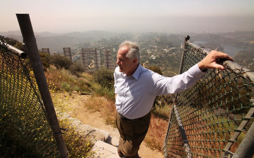 LOS ANGELES, CA - APRIL 26: Tom LaBonge died on January 7, 2021 at the age of 67. LaBonge was a member of the Los Angeles City Council representing the 4th district, serving from 2001 to 2015 and was a advocate for Griffith Park, one of the largest urban parks in the nation, which fell in his council district. On April, 26, 2010 Tom walks on Mount Lee above the Hollywood Sign following a press conference to announce that a $900,000 donation from Hugh Hefner of Playboy Enterprises closed the gap on their Save the Peak campaign to buy 138 acres of hillside beside the famed Hollywood Sign from developers. Griffith Park on Monday, April 26, 2010 in Los Angeles, CA. (Al Seib / Los Angeles Times)