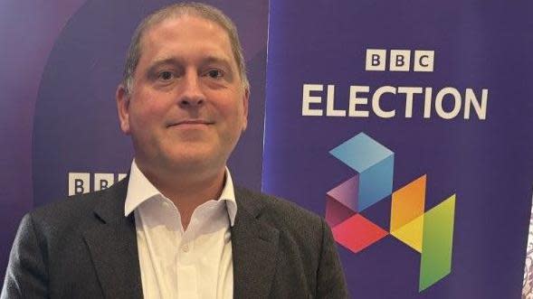 Ben Fletcher in front of a BBC Election 24 banner