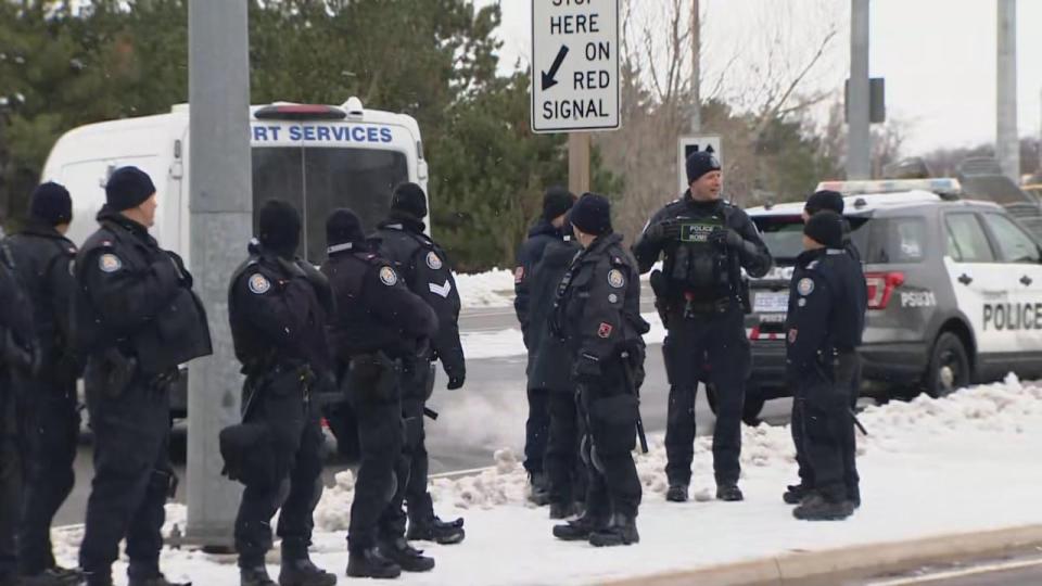 A group of Toronto police officers at the scene of Saturday's arrests. (CBC - image credit)